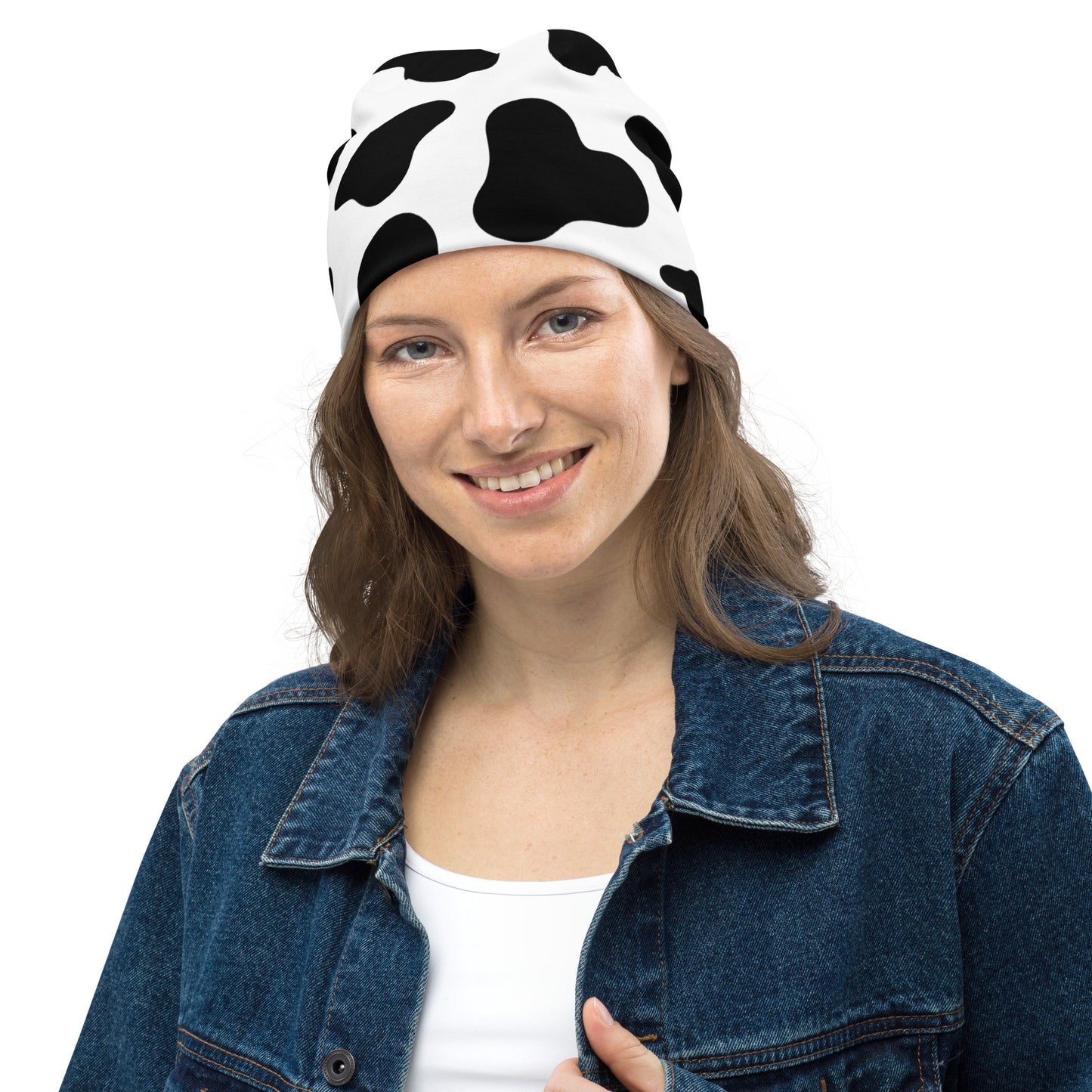 Model wearing unisex cow print beanie hat in black and white, soft double-layer knit, front view