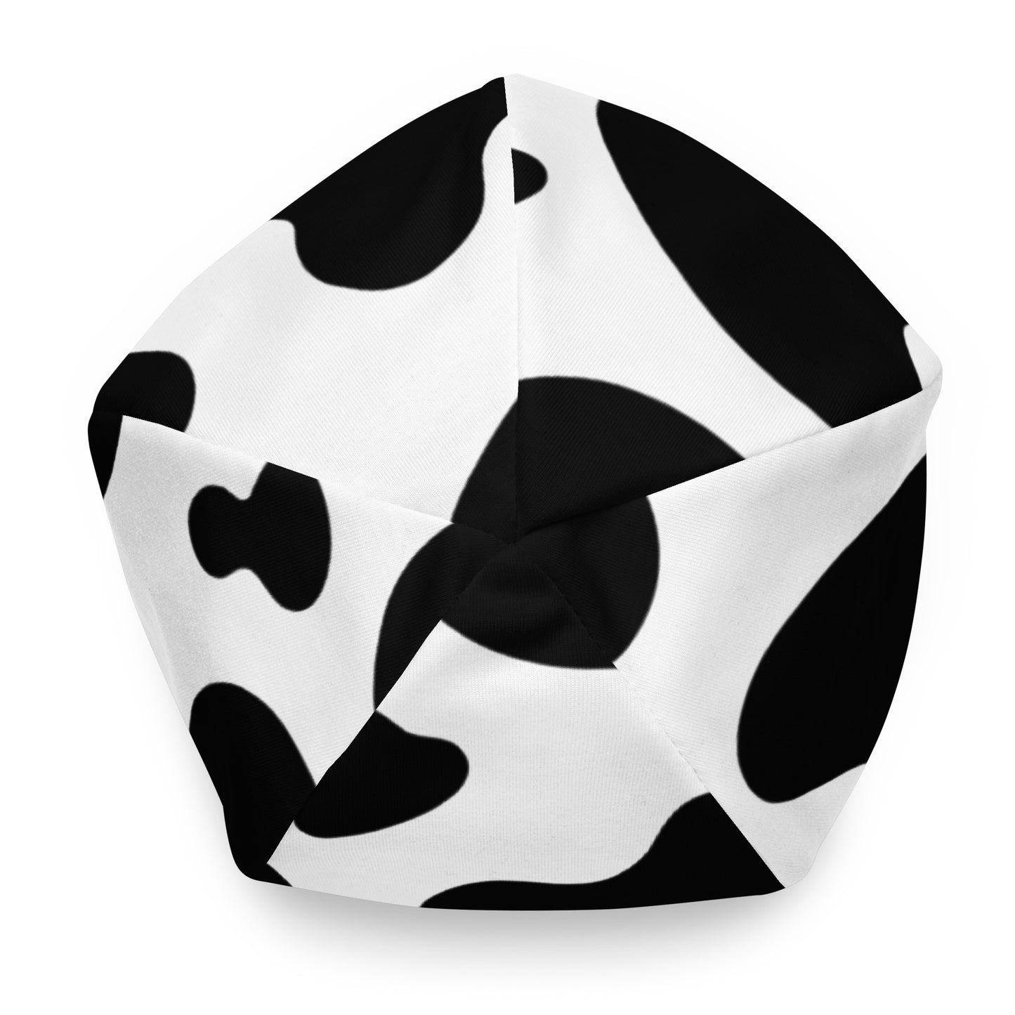 Unisex cow print beanie hat in black and white, soft double-layer knit, top view