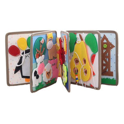 Busy book half open showing farm animals and fruit pages for toddlers