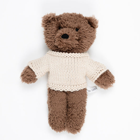 Chocolate plush teddy bear wearing cream merino wool sweater on white background – Mamutino