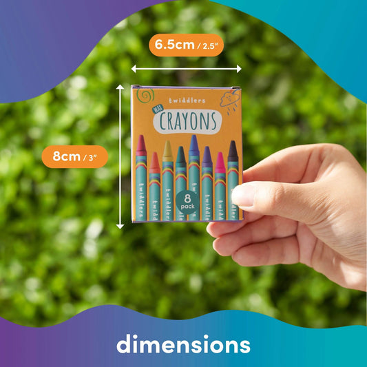 Hand holding a box of crayons with dimensions displayed against a green leafy background