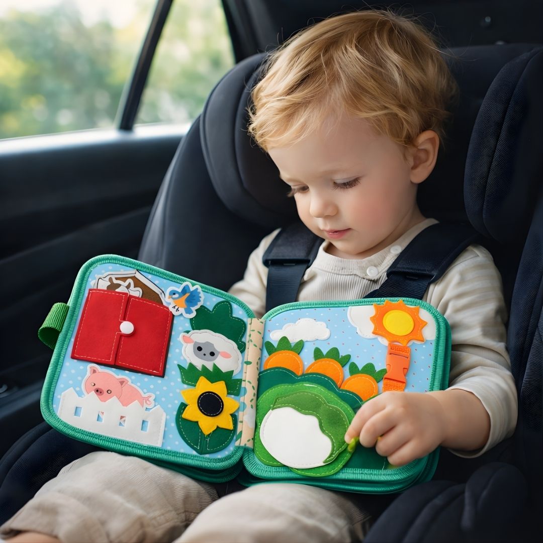 Toddler using a farm animals busy book while sitting in a car seat, showing quiet and travel-friendly play


