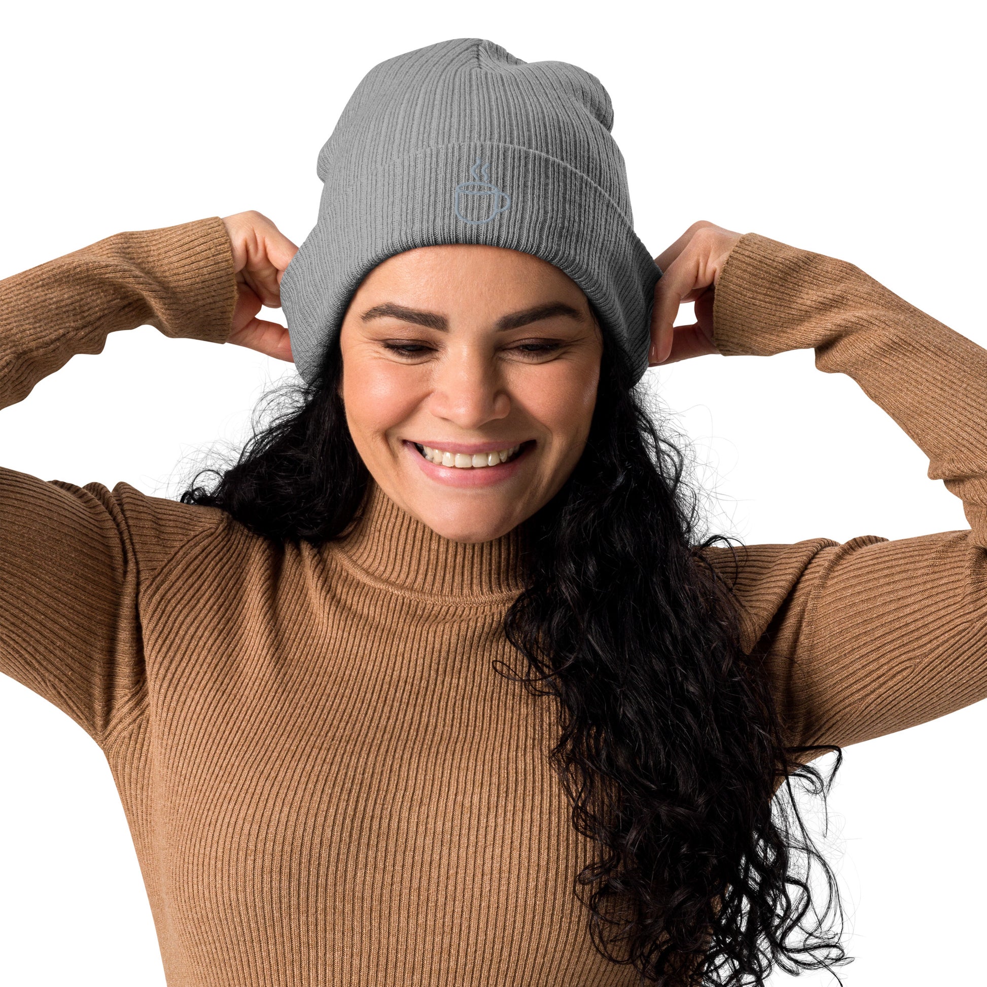 Model wearing ribbed knit beanie hat in light grey with embroidered coffee cup design, front view
