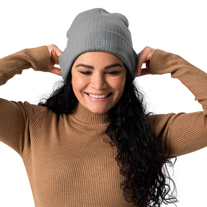 Model wearing ribbed knit beanie hat in light grey with embroidered coffee cup design, front view